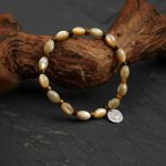 Grounded Radiance: Beige Trochus Shell & Golden Tiger Eye Protection Bracelet